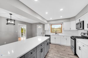 After A kitchen with white cabinets and gray counter tops, featuring a whiting concrete countertop.